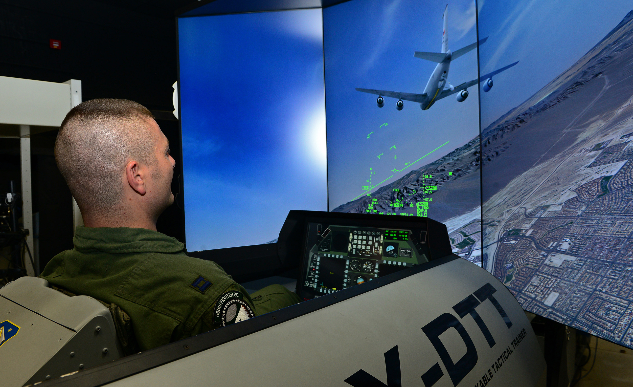 555th Fighter Squadron F-16 Fighting Falcon pilot, operates an F-16 simulator, at Aviano Air Base, Italy. The multi-channel synchronized view is driven by MetaVR VRSG. (U.S. Air Force photo by Senior Airman Matthew Lotz/Released.)